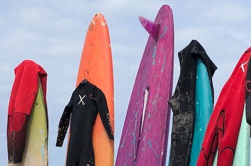 wetsuit hanging on surfboard